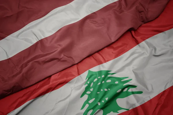 Размахивая Разноцветным Флагом Либанона Национальным Флагом Латвии Macro — стоковое фото