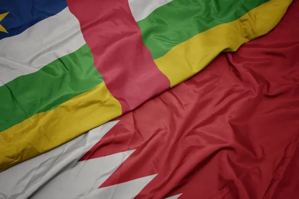 waving colorful flag of bahrain and national flag of central african republic. macro