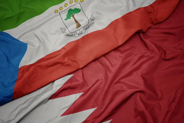 waving colorful flag of bahrain and national flag of equatorial guinea. macro