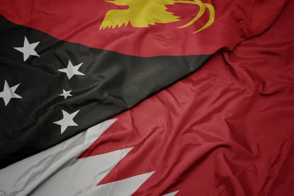 Vlající Barevnou Vlajkou Bahrainu Národní Vlajkou Papuy Nové Guineje Makro — Stock fotografie