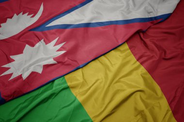 Mali 'nin renkli bayrağı ve Nepal' in ulusal bayrağı sallanıyor. makro