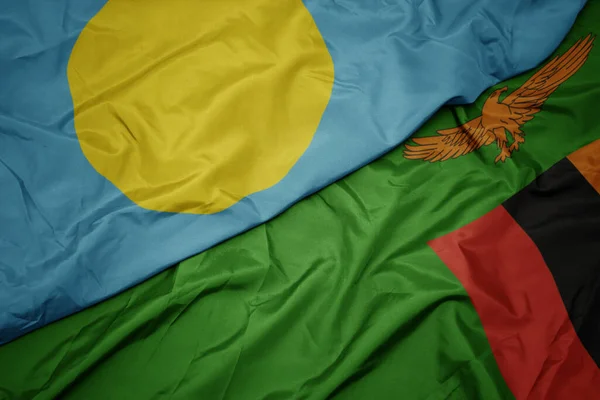 waving colorful flag of zambia and national flag of Palau . macro