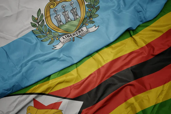 Viftande Färgglada Flagga Zimbabwe Och Nationell Flagga San Marino Makro — Stockfoto