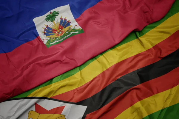 Κυματίζει Πολύχρωμη Σημαία Της Zimbabwe Και Εθνική Σημαία Της Αϊτής — Φωτογραφία Αρχείου