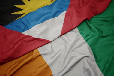 Cote Divoire 'ın renkli bayrağı, antigua ve barbuda' nın ulusal bayrağı sallanıyor. makro