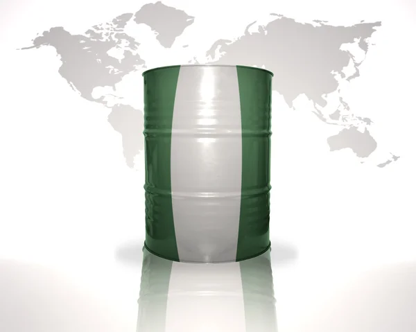 Barrel with nigerian flag on the world map background — Stock Photo, Image