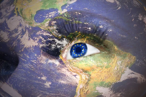 Woman's face with planet Earth texture and european union flag inside the eye — Stockfoto