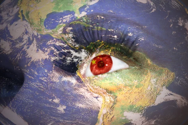 Woman's face with planet Earth texture and chinese flag inside the eye — Stockfoto