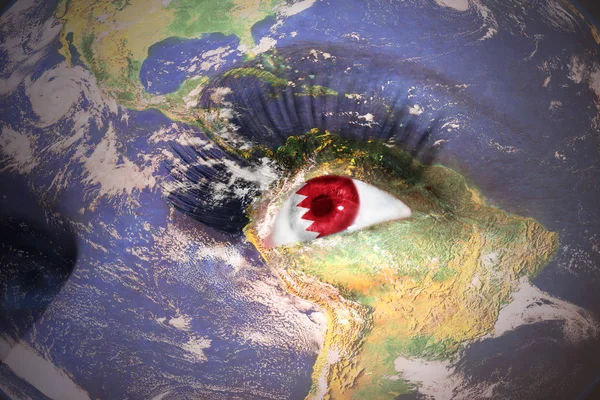 Woman's face with planet Earth texture and bahrain flag inside the eye — Stockfoto