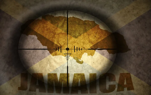 Sniper scope aimed at the vintage jamaican flag and map — Stock Photo, Image