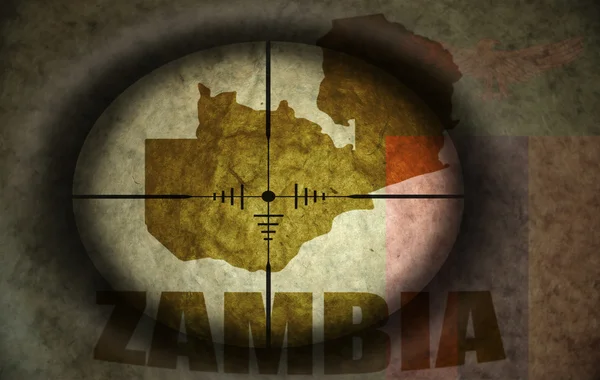 Sniper scope aimed at the vintage zambian flag and map — Stock Photo, Image