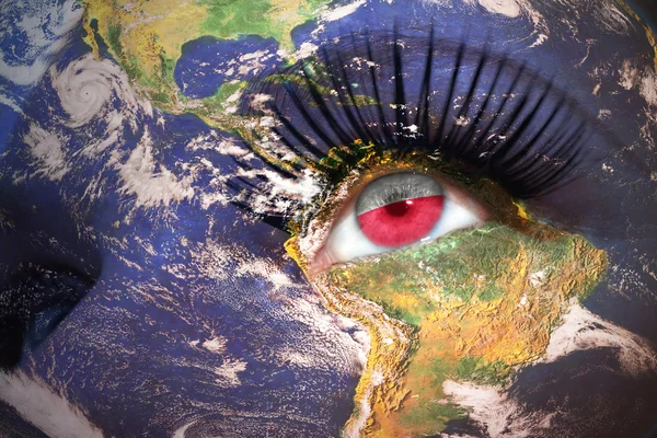 Woman's face with planet Earth texture and polish flag inside the eye — Stock Photo, Image