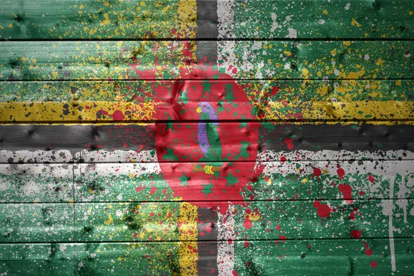 Painted dominica flag on a wooden texture — Stock Photo, Image