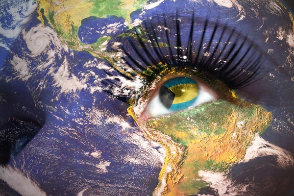 Womans face with planet Earth texture and bahamas flag inside the eye — Stockfoto