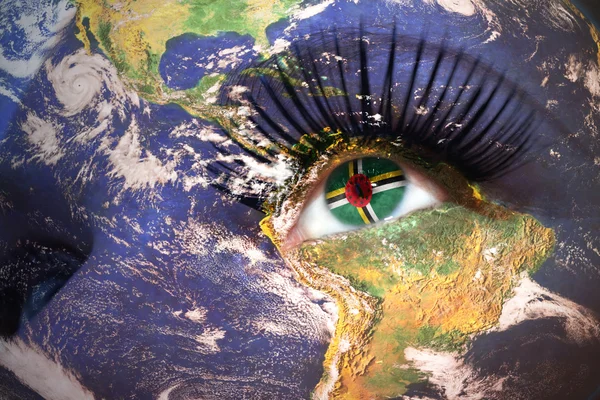 Womans face with planet Earth texture and dominica flag inside the eye — 图库照片