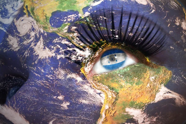Womans face with planet Earth texture and honduran flag inside the eye — Stockfoto