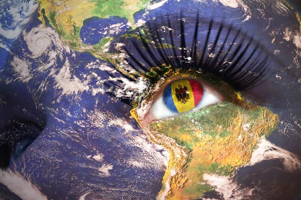 Woman's face with planet Earth texture and moldavian flag inside the eye. — Stockfoto