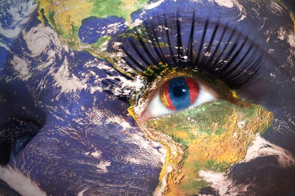 Womans face with planet Earth texture and mongolian flag inside the eye. — Stockfoto