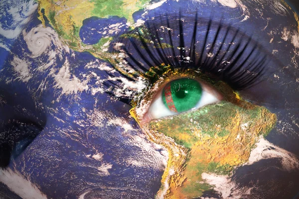 Womans face with planet Earth texture and turkmenistan flag inside the eye. — Stockfoto