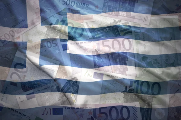 Colorful waving greek flag on a euro money background — ストック写真