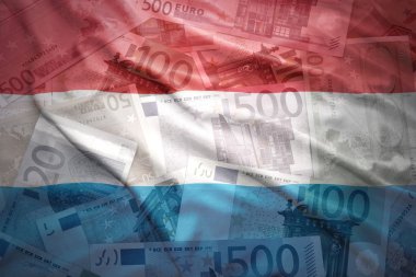 colorful waving luxembourg flag on a euro money background