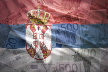 colorful waving serbian flag on a euro money background