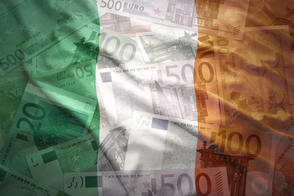 Colorful waving irish flag on a euro money background — Stockfoto