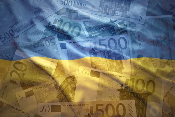 Colorful waving ukrainian flag on a euro money background — 图库照片
