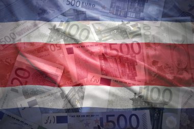 colorful waving costa rican flag on a euro money background
