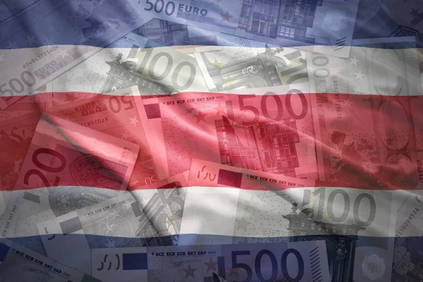 Colorful waving costa rican flag on a euro money background — Stock Photo, Image