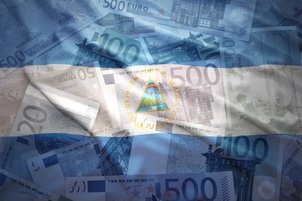 Colorful waving nicaraguan flag on a euro money background — Zdjęcie stockowe