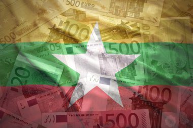 colorful waving myanmar flag on a euro money background