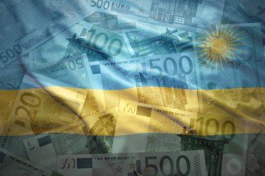 colorful waving rwandan flag on a euro money background