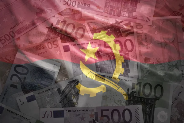 Colorful waving angolan flag on a euro money background — 图库照片