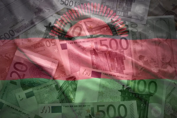 Colorful waving malawi flag on a euro money background — Stockfoto