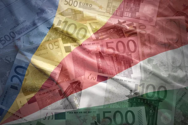 Colorful waving seychelles flag on a euro money background — Stock Photo, Image