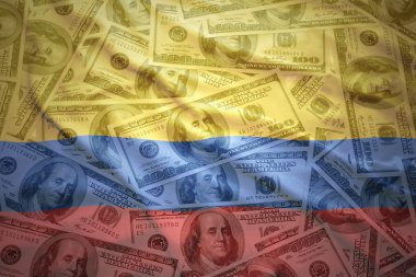 colorful waving colombian flag on a american dollar money background