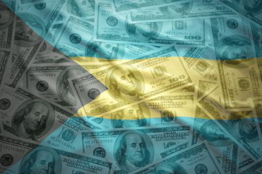 colorful waving bahamas flag on a american dollar money background