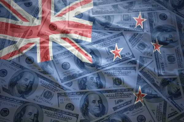 Colorful waving new zealand flag on a american dollar money background — Stock Photo, Image