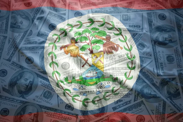 Colorido acenando bandeira belize em um fundo de dinheiro dólar americano — Fotografia de Stock