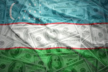 colorful waving uzbek flag on a american dollar money background