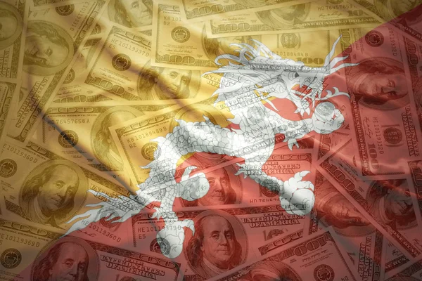 Colorful waving bhutan flag on a american dollar money background — Zdjęcie stockowe