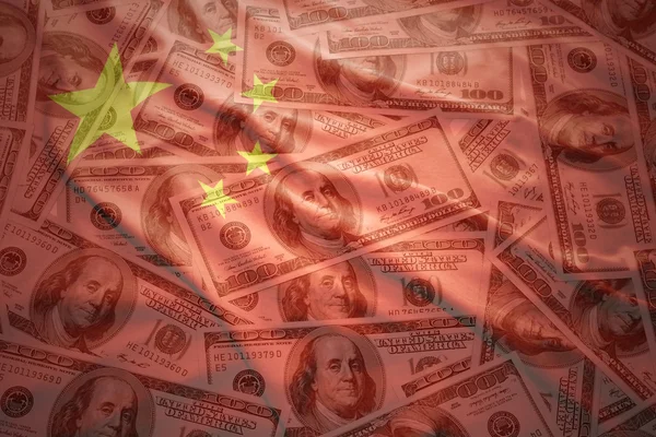 Colorful waving chinese flag on a american dollar money background — ストック写真