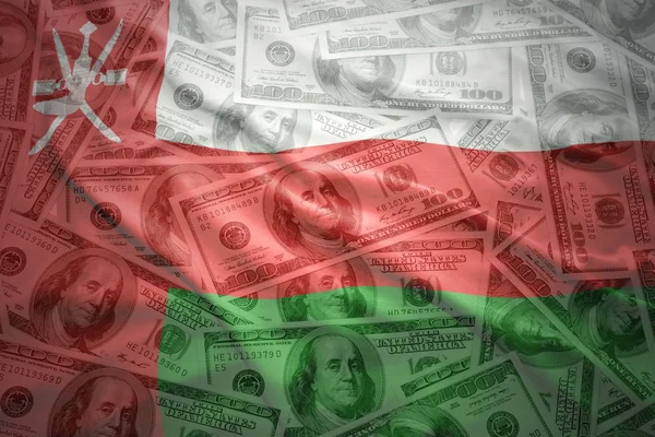 Colorful waving omani flag on a american dollar money background — Stok fotoğraf