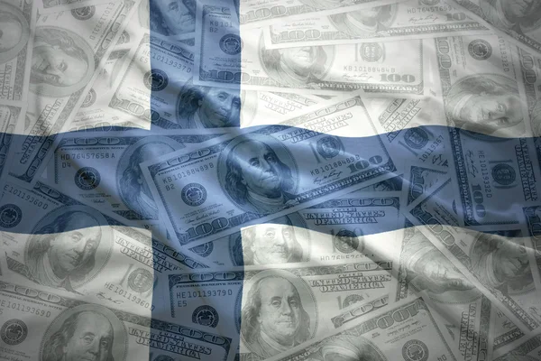 Bandera finlandesa ondeante colorida en un dólar americano — Foto de Stock