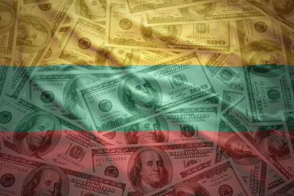 Colorful waving lithuanian flag  on a american dollar money — Stock Photo, Image