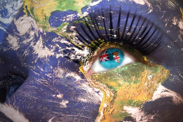 Womans face with planet Earth texture and fiji flag inside the eye. — Stock Photo, Image