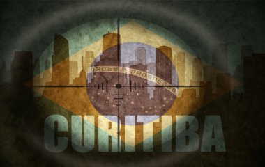 sniper scope aimed at the abstract silhouette of the city with text Curitiba at the vintage brazilian flag