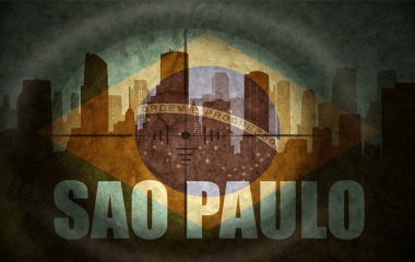 sniper scope aimed at the abstract silhouette of the city with text Sao Paulo at the vintage brazilian flag