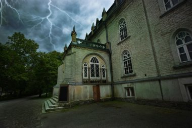 Ancient mystical sinister house during a thunderstorm